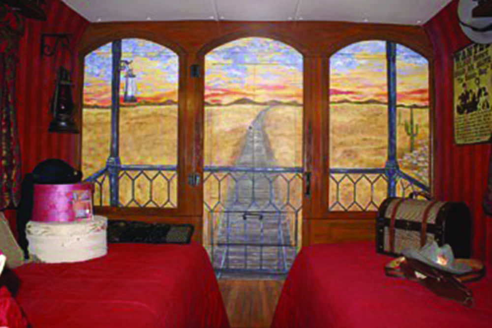 Bedroom rear wall mural (The three panels are cabinet doors with storage behind.)