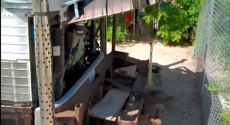 The rear of the bus with a motorcycle ramp.