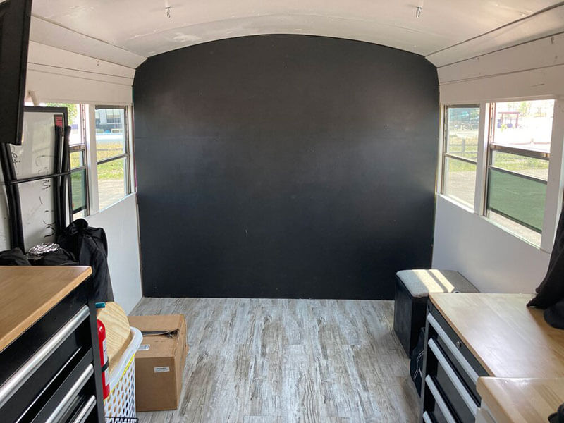 Murphy bed ﬂipped up creates the photo studio.