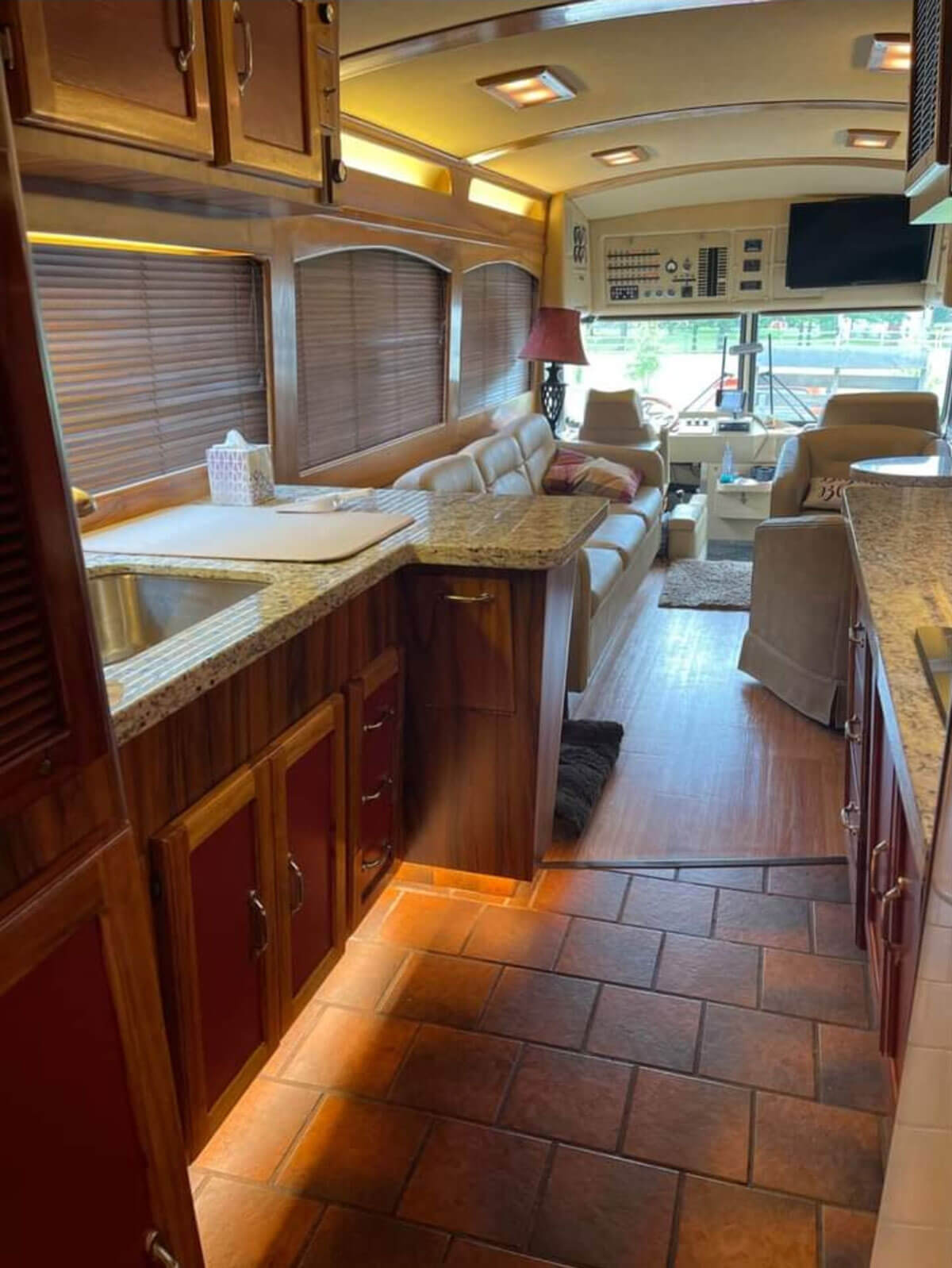 This image has an empty alt attribute; its file name is Granite-countertops-original-tile-flooring-and-cabinets-with-underlighting.-There-is-a-pull-open-door-w.jpg