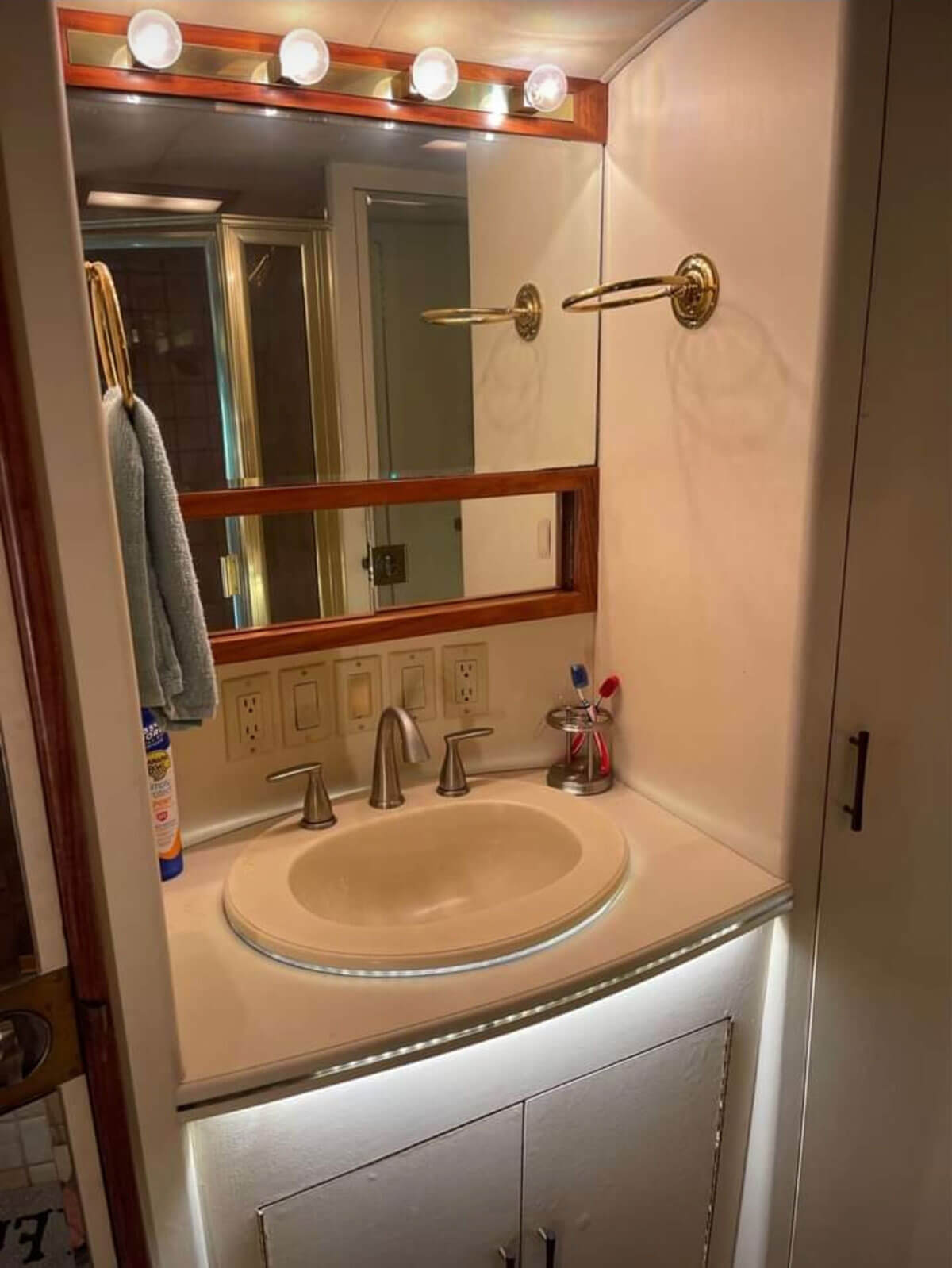 This image has an empty alt attribute; its file name is The-bathroom-sink-area-with-a-mirrored-medicine-cabinet-and-built-in-lighting.jpg