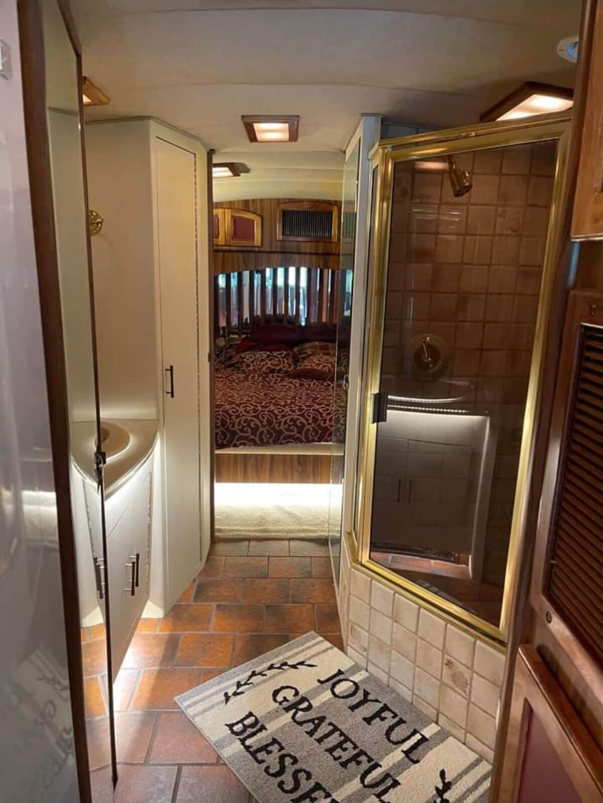 This image has an empty alt attribute; its file name is The-original-tiled-shower-has-a-small-tub-built-in.-This-bathroom-has-two-full-length-beveled-mirrors-do.jpg