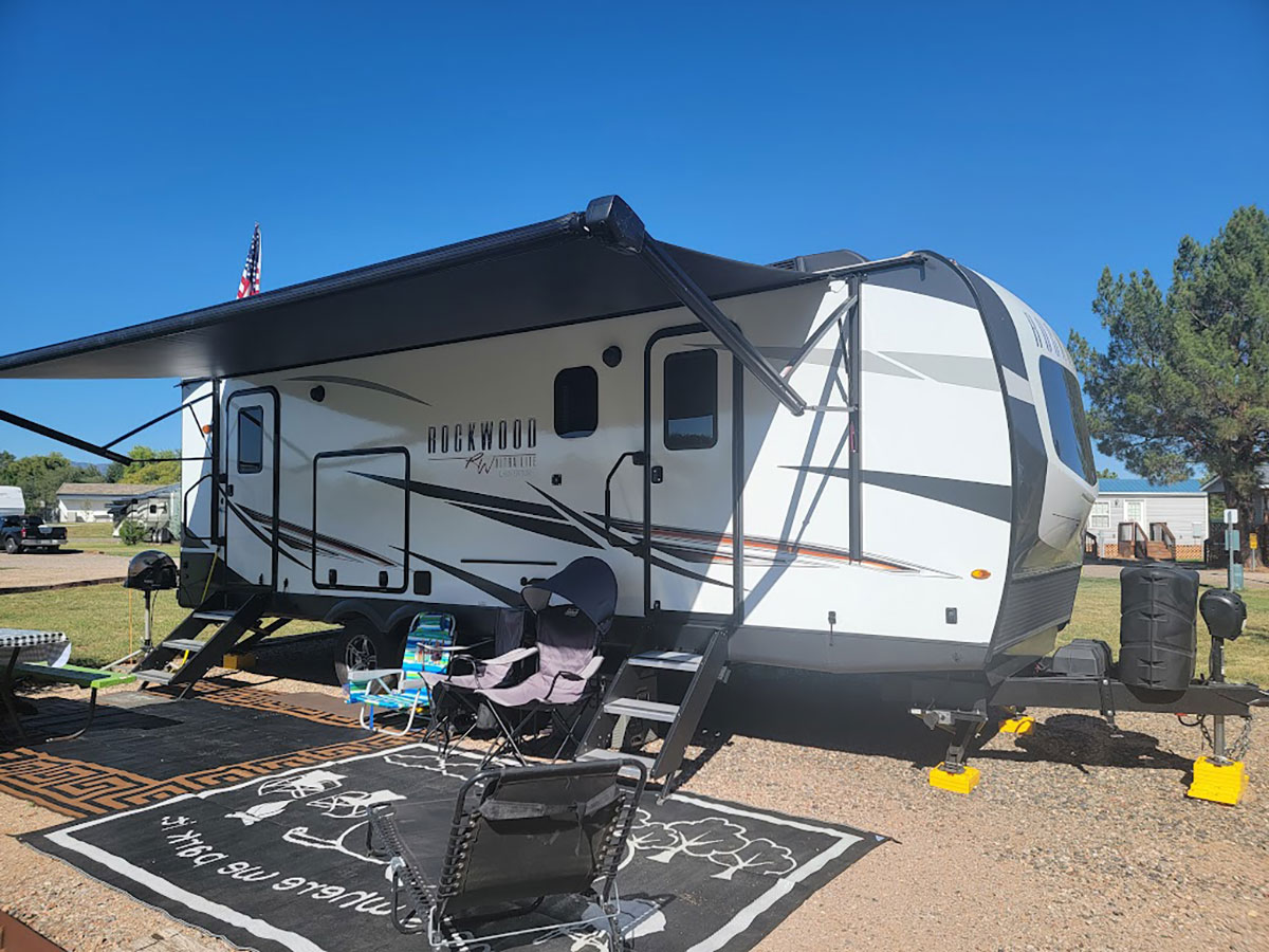 A Travel Trailer with windows in both entrance doors and one other smaller window on this side of the unit, probably over the sink.