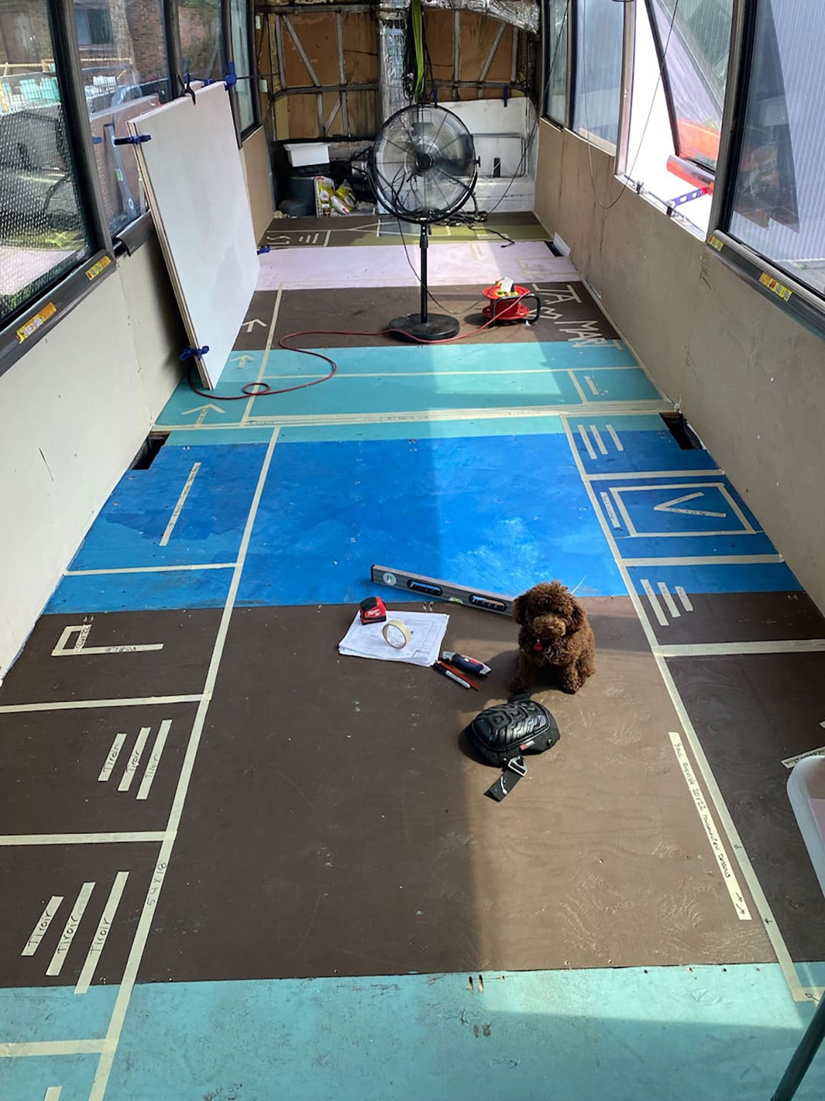 Laying out the floor plan with tape.